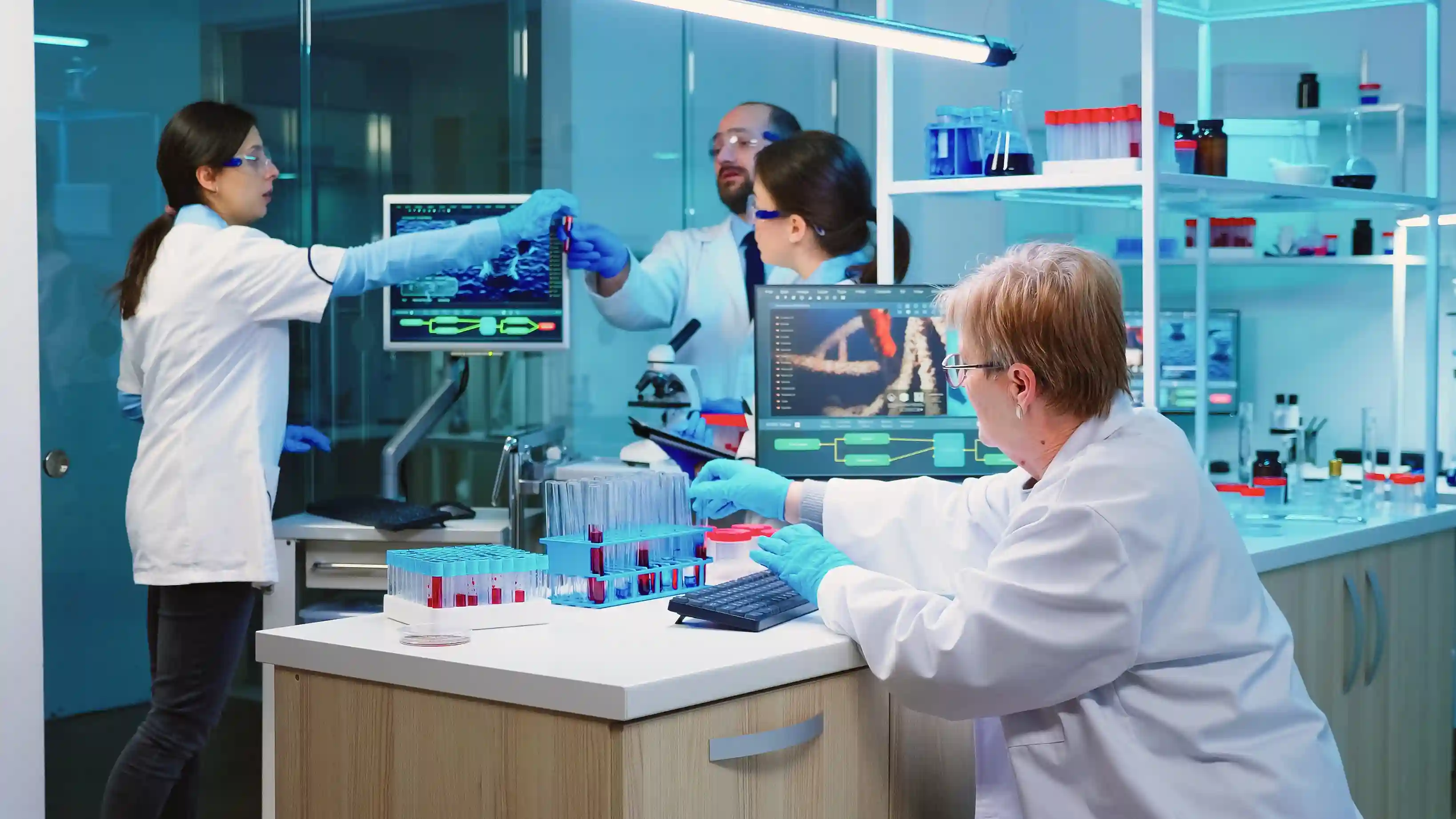 four lab technicians working in a laboratory